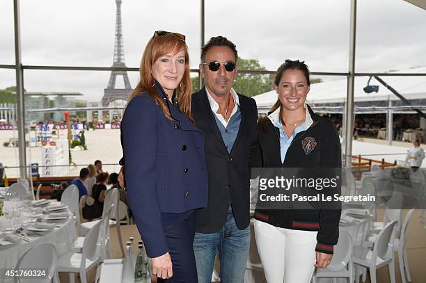 Bruce Springsteen and his wife Patti Scialfa pose with their daughter Jessica Springsteen during the Paris Eiffel Jumping presented by Gucci at...
