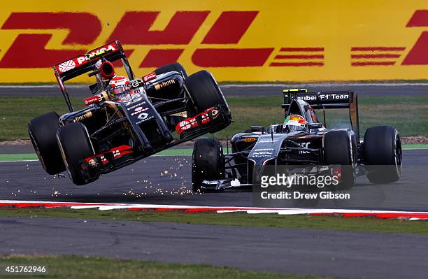 Pastor Maldonado of Venezuela and Lotus crashes with Esteban Gutierrez of Mexico and Sauber F1 during the British Formula One Grand Prix at...
