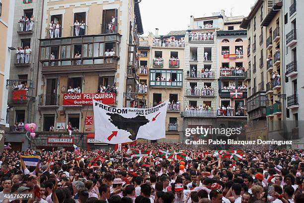 Protest banner reading 'Freedom Basque prisioners and exiles!' is lifted while thousands of revellers sing and dance during the opening and the...