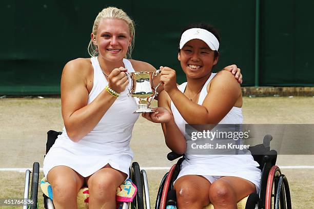 Jordanne Whiley of Great Britain and Yui Kamiji of Japan celebrate with the trophy after winning their Ladies' Wheelchair Doubles Final match against...