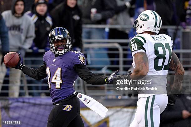 Cornerback Corey Graham of the Baltimore Ravens celebrates in front of tight end Kellen Winslow of the New York Jets after making an interception in...