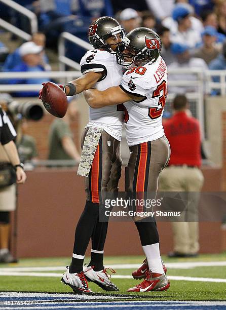 Tiquan Underwood of the Tampa Bay Buccaneers celebrates his fourth quarter touchdown catch against the Detroit Lions with Brian Leonard at Ford Field...