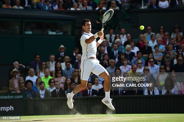 Serbia's Novak Djokovic returns to Switzerland's Roger Federer during their men's singles final match on day thirteen of the 2014 Wimbledon...