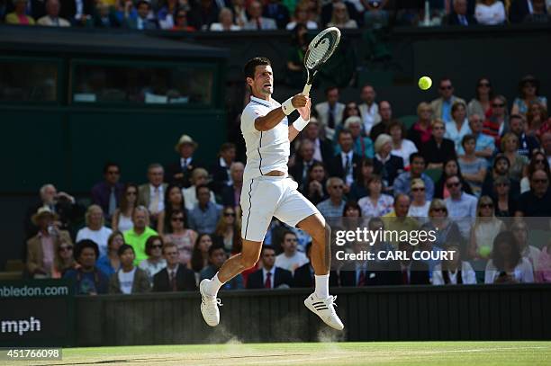 Serbia's Novak Djokovic returns to Switzerland's Roger Federer during their men's singles final match on day thirteen of the 2014 Wimbledon...