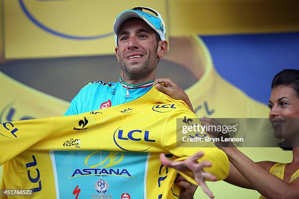 Vincenzo Nibali of Italy and the Astana Pro Team takes the yellow jersey after winning the second stage of the 2014 Tour de France, a 201km stage...