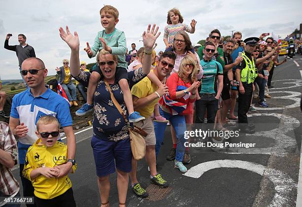 Fans crowd the sides of the course as they support the riders during stage two of the 2014 Le Tour de France from York to Sheffield on July 6, 2014...