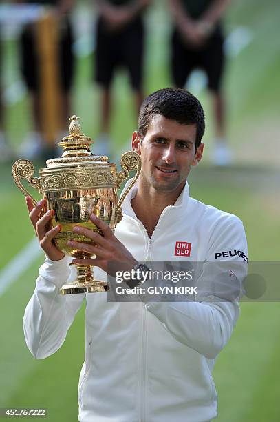 Serbia's Novak Djokovic holds the winner's trophy after beating Switzerland's Roger Federer in the men's singles final match during the presentation...