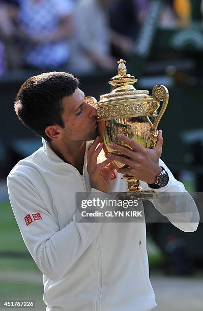 Serbia's Novak Djokovic holds the winner's trophy after beating Switzerland's Roger Federer in the men's singles final match during the presentation...