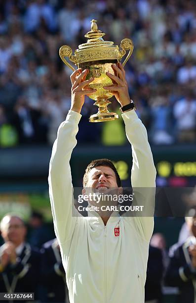 Serbia's Novak Djokovic holds the winner's trophy after beating Switzerland's Roger Federer in the men's singles final match during the presentation...