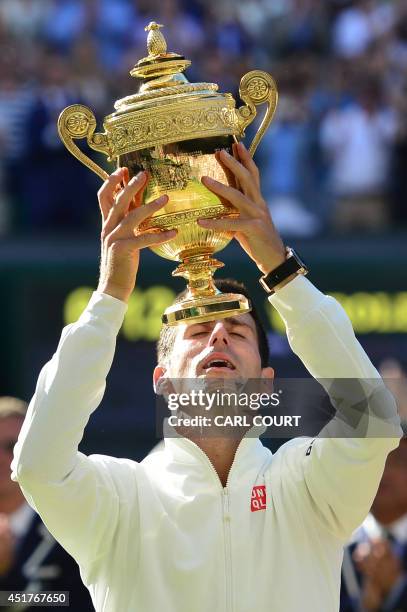 Serbia's Novak Djokovic holds the winner's trophy after beating Switzerland's Roger Federer in the men's singles final match during the presentation...