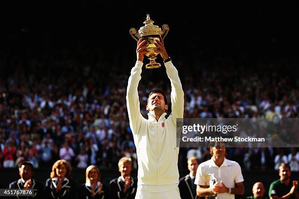 Novak Djokovic of Serbia poses with the Gentlemen's Singles Trophy following his victory in the Gentlemen's Singles Final match against Roger Federer...