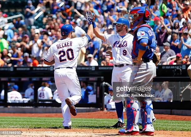 Anthony Recker of the New York Mets celebrates his first inning three-run home run against the Texas Rangers with teammate Kirk Nieuwenhuis at Citi...