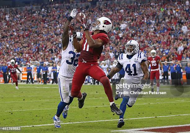 Wide receiver Larry Fitzgerald of the Arizona Cardinals catches a touchdown reception past cornerback Cassius Vaughn strong safety Antoine Bethea of...