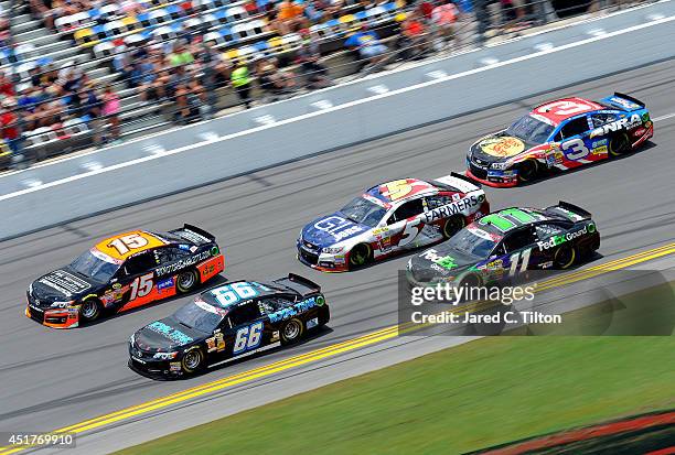 Clint Bowyer, driver of the RK Motors Charlotte Toyota, and Michael Waltrip, driver of the RoyalTeakCollection.com Toyota, lead a pack of cars during...