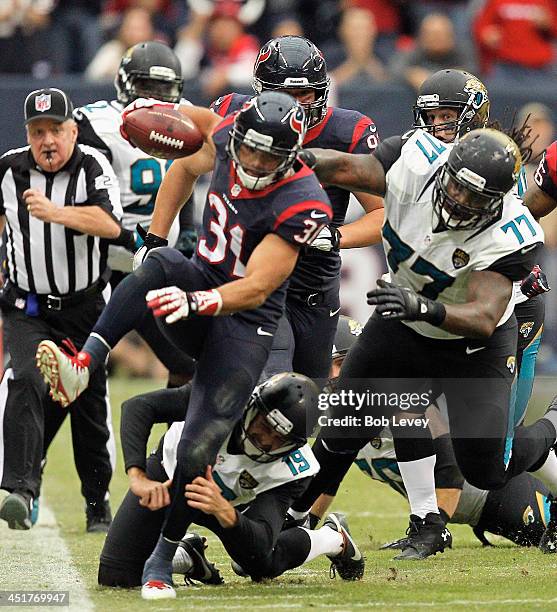 Shiloh Keo of the Houston Texans is tackled after picking up a blocked field goal attempt by Bryan Anger of the Jacksonville Jaguars and Uche Nwaneri...