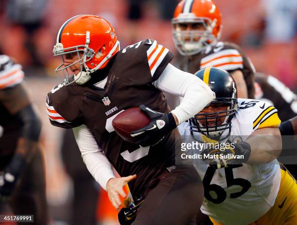 Defensive end Al Woods of the Pittsburgh Steelers sacks quarterback Brandon Weeden of the Cleveland Browns at FirstEnergy Stadium on November 24,...