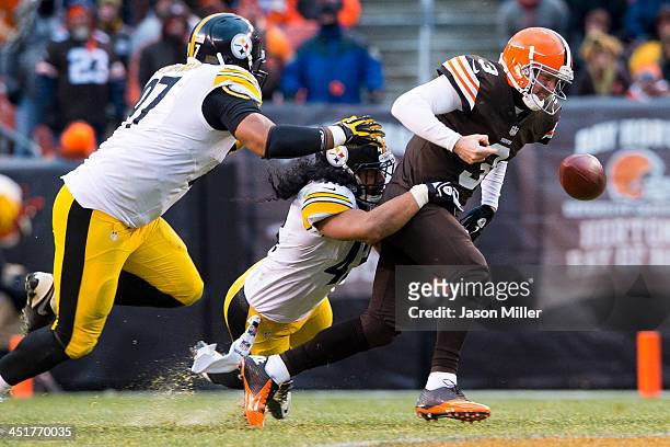 Defensive end Cameron Heyward and strong safety Troy Polamalu of the Pittsburgh Steelers sack quarterback Brandon Weeden of the Cleveland Browns...