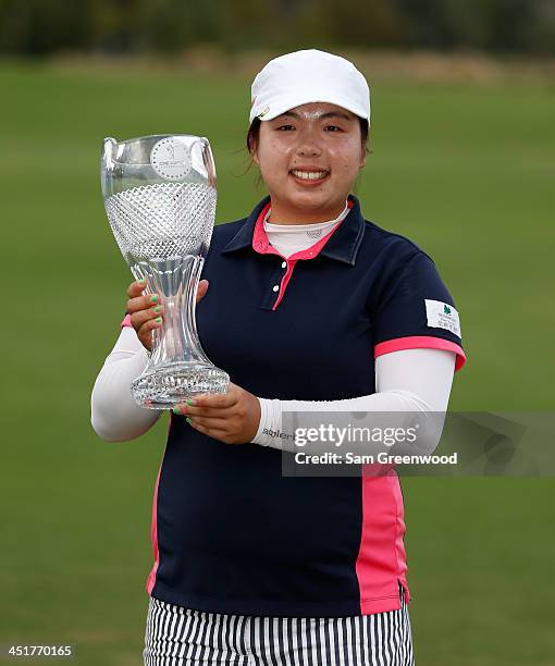 Shanshan Feng of China poses with the trophy after winning the CME Group Titleholders at Tiburon Golf club on November 24, 2013 in Naples, Florida.