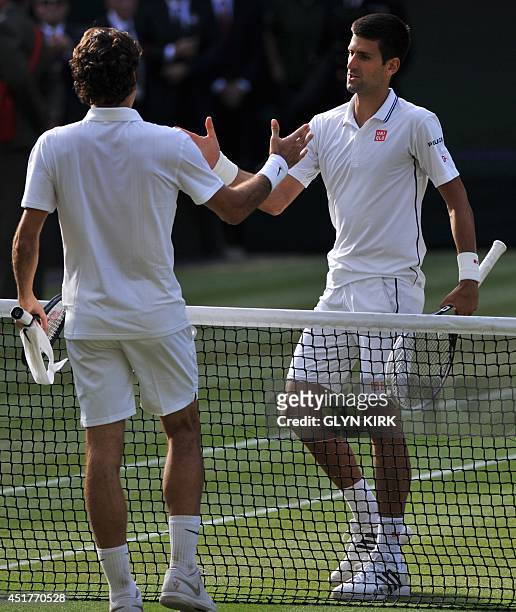Serbia's Novak Djokovic shakes hands with Switzerland's Roger Federer after the former won their men's singles final match on day thirteen of the...
