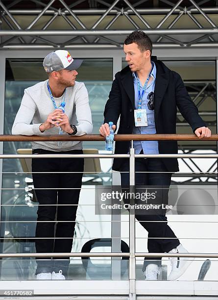 Cricketeers Stuart Broad of England and Peter Siddle of Australia during the British Formula One Grand Prix at Silverstone Circuit on July 6, 2014 in...