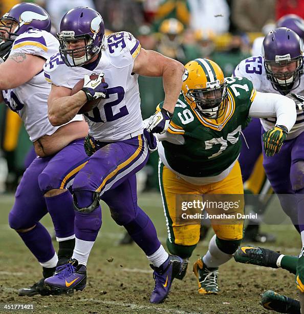 Toby Gerhart of the Minnesota Vikings runs past Ryan Pickett of the Green Bay Packers at Lambeau Field on November 24, 2013 in Green Bay, Wisconsin....