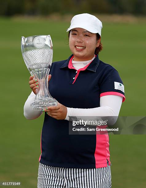 Shanshan Feng of China poses with the trophy after winning the CME Group Titleholders at Tiburon Golf club on November 24, 2013 in Naples, Florida.