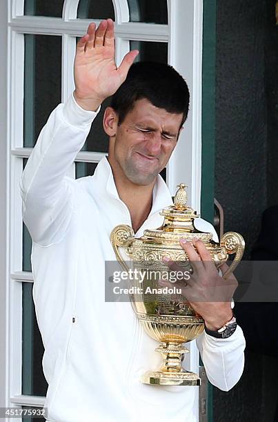 Novak Djokovic of Serbia poses with the Gentlemen's Singles Trophy after defeating his opponent Roger Federer 3-2 in the Gentlemen's Singles Final...