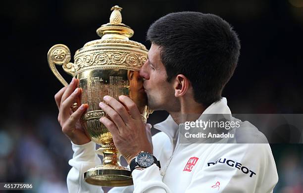 Novak Djokovic of Serbia poses with the Gentlemen's Singles Trophy after defeating his opponent Roger Federer 3-2 in the Gentlemen's Singles Final...