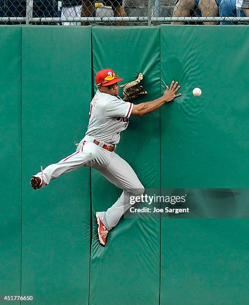 Ben Revere of the Philadelphia Phillies can't make a catch on a ball hit by Andrew McCutchen of the Pittsburgh Pirates during the eighth inning on...