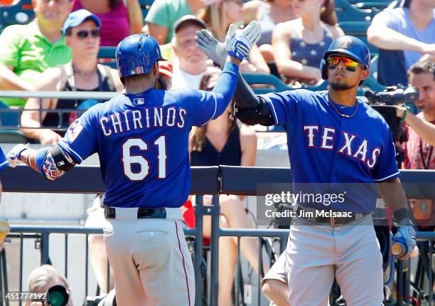 Robinson Chirinos of the Texas Rangers celebrates his fourth inning home run against the New York Mets with teammate Rougned Odor at Citi Field on...