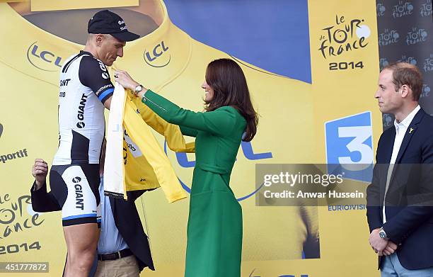 Watched by Prince William, Duke of Cambridge, Catherine, Duchess of Cambridge gives the yellow jersey to Marcel Kittel, the winner of Stage 1 of the...