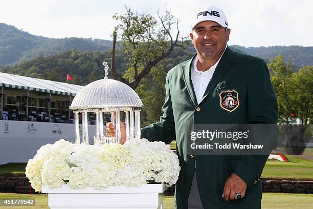 Angel Cabrera of Argentina holds the trophy after winning the Greenbrier Classic at the Old White TPC on July 6, 2014 in White Sulphur Springs, West...