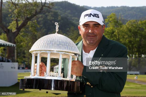 Angel Cabrera of Argentina holds the trophy after winning the Greenbrier Classic at the Old White TPC on July 6, 2014 in White Sulphur Springs, West...