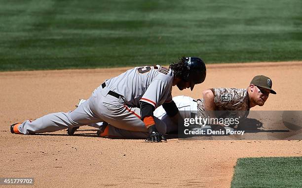 Brooks Conrad of the San Diego Padres tangles with Brandon Crawford of the San Francisco Giants after getting the force out at second base during the...