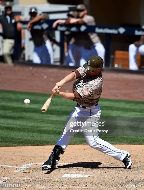 Brooks Conrad of the San Diego Padres hits a solo home run during the seventh inning of a baseball game against the San Francisco Giants at Petco...