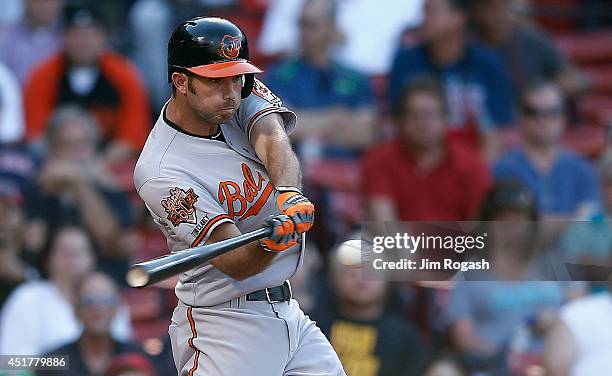 Hardy of the Baltimore Orioles singles in the winning run in the 12th inning against the Boston Red Sox at Fenway Park on July 6, 2014 in Boston,...