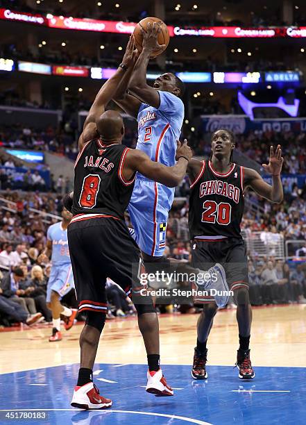 Darren Collison of the Los Angeles Clippers shoots over Mike James of the Chicago Bulls at Staples Center on November 24, 2013 in Los Angeles,...