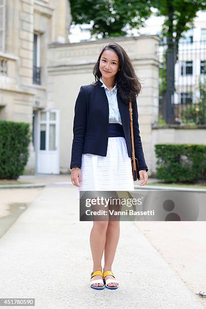 Eloise Goh poses wearing a Gerard Darel jacket, Zara shirt,Tara Jarmon skirt and Carel shoes before Stephanie Coudert show on July 6, 2014 in Paris,...