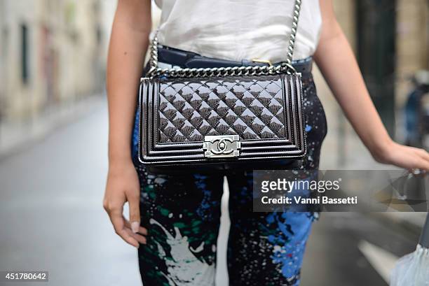 Fashion blogger Elvira Abasova poses wearing an Iro top, Tibi pants and a Chanel bag before Fred Sathal show on July 6, 2014 in Paris, France.