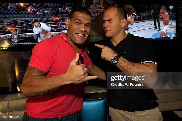 Mixed martial artists Antonio 'Bigfoot' Silva and Junior Dos Santos pose at the UFC Brazilian party during UFC International Fight Week inside the...