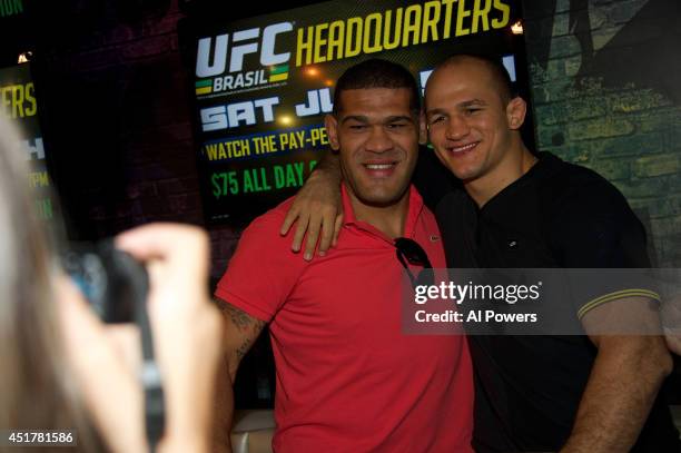 Mixed martial artists Antonio 'Bigfoot' Silva and Junior Dos Santos pose at the UFC Brazilian party during UFC International Fight Week inside the...