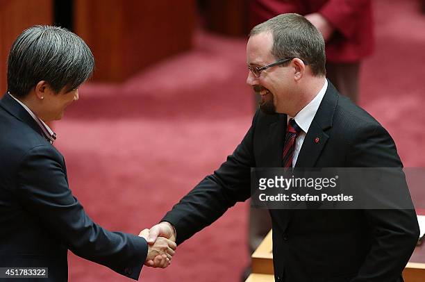 Senator for Victoria Ricky Muir is congratulated by Senator Penny Wong during an official ceremony at Parliament on July 7, 2014 in Canberra,...