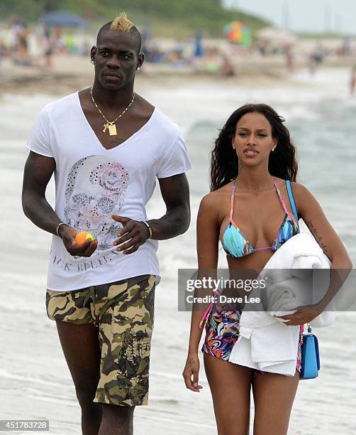 Mario Balotelli and Fanny Neguesha are seen on the beach in Miami Beach on July 6, 2014 in Miami, Florida.