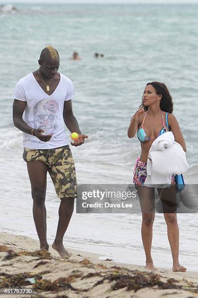 Mario Balotelli and Fanny Neguesha are seen on the beach in Miami Beach on July 6, 2014 in Miami, Florida.