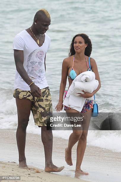 Mario Balotelli and Fanny Neguesha are seen on the beach in Miami Beach on July 6, 2014 in Miami, Florida.