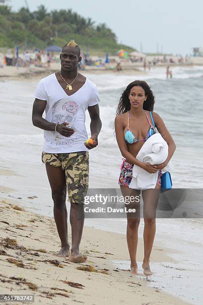 Mario Balotelli and Fanny Neguesha are seen on the beach in Miami Beach on July 6, 2014 in Miami, Florida.