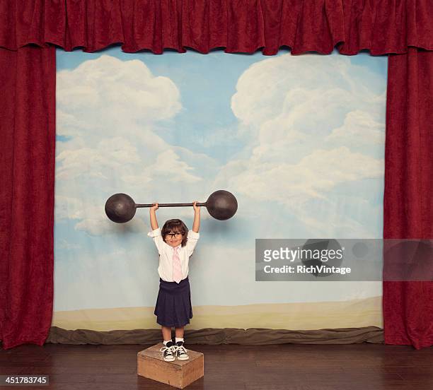 young business girl lifts barbell on stage - tiny mexican girl stock pictures, royalty-free photos & images