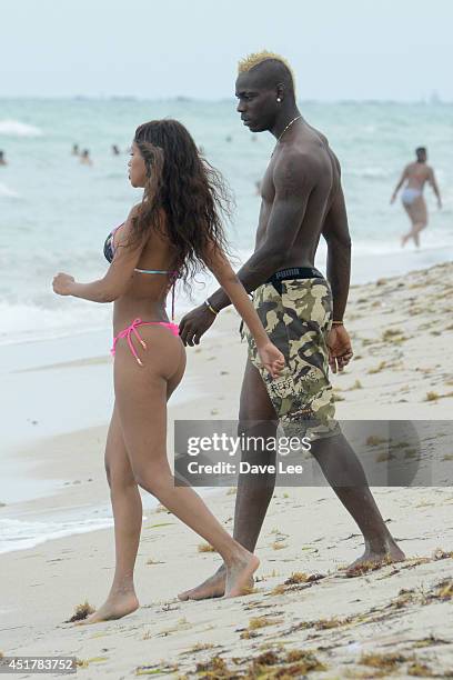 Mario Balotelli and Fanny Neguesha are seen on the beach in Miami Beach on July 6, 2014 in Miami, Florida.