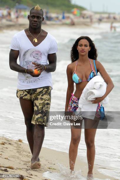 Mario Balotelli and Fanny Neguesha are seen on the beach in Miami Beach on July 6, 2014 in Miami, Florida.