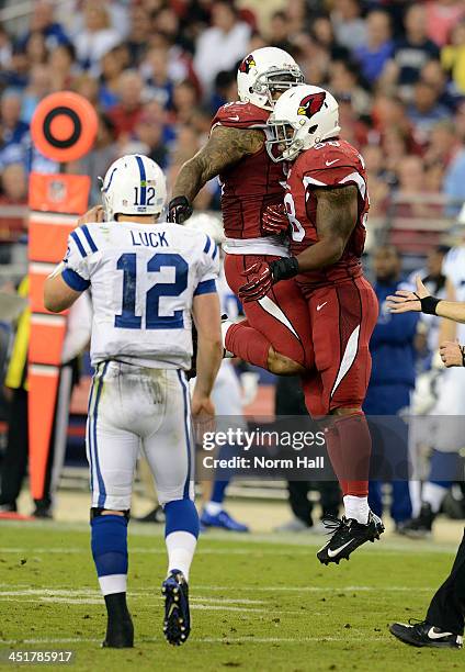 Darnell Dockett and teammate Daryl Washington of the Arizona Cardinals celebrate as Andrew Luck of the Indianapolis Colts walks off the field at...